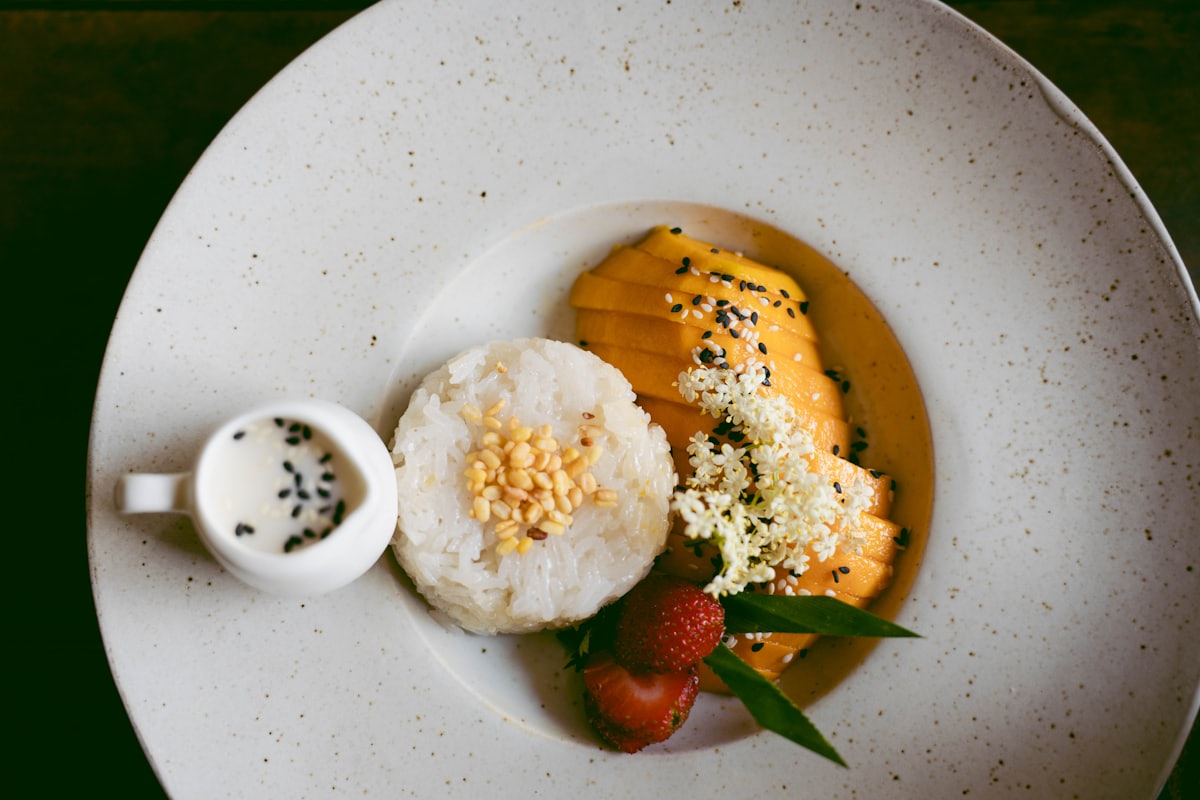 A tray of biko, glossy dark sticky rice cake cut into squares and topped with golden latik curds